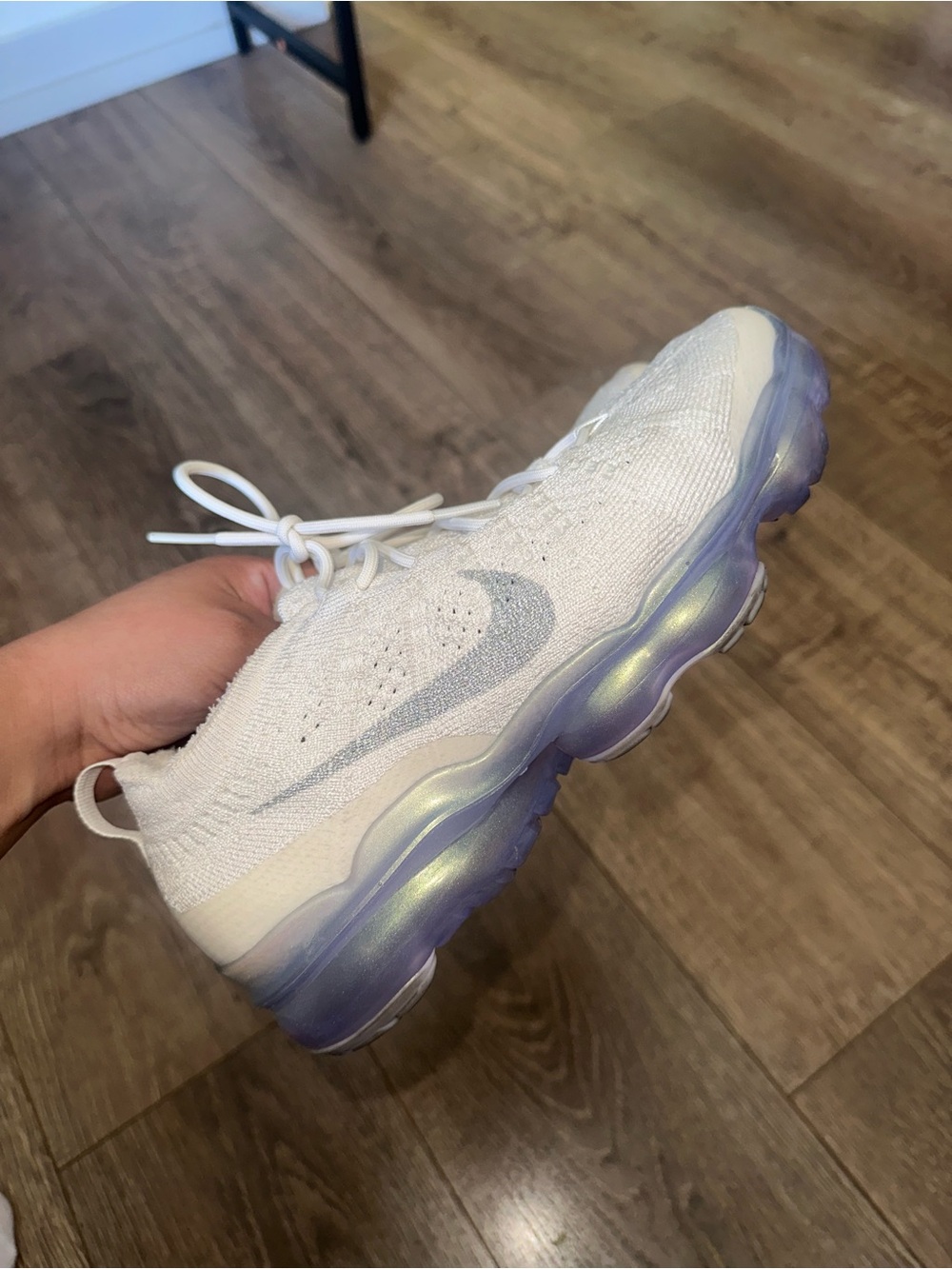 Nike Women's size 7.5 White Flyknit Sneaker with Iridescent Purple Sole